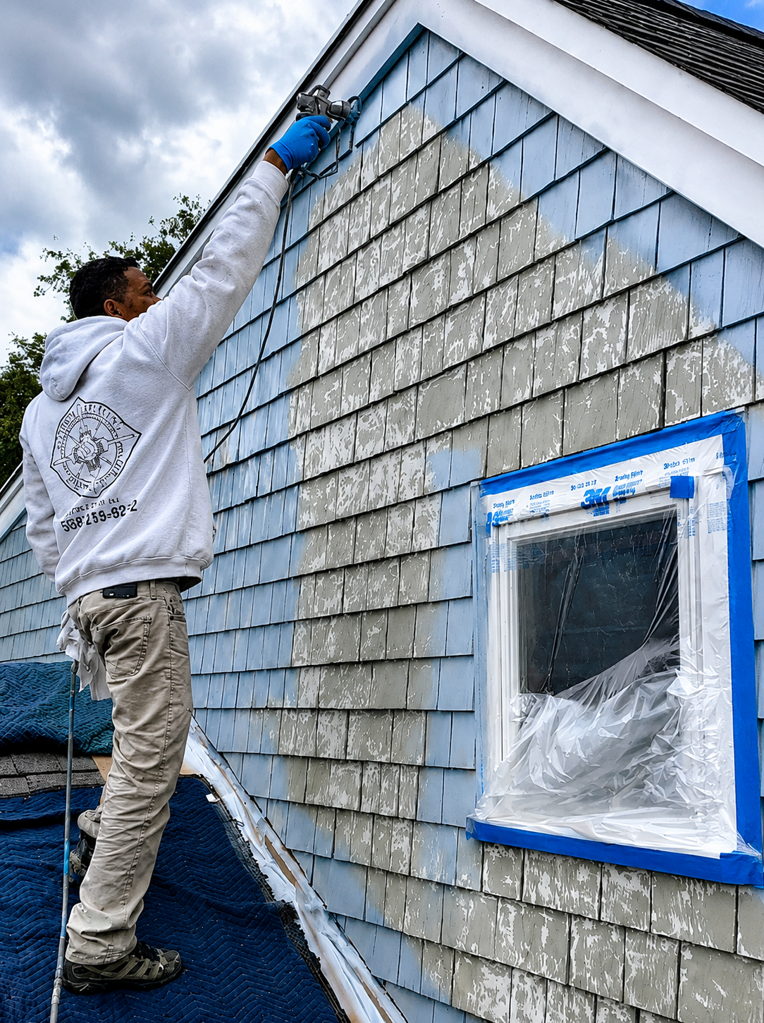 Compass Painting technician preparing exterior siding before painting on Cape Cod